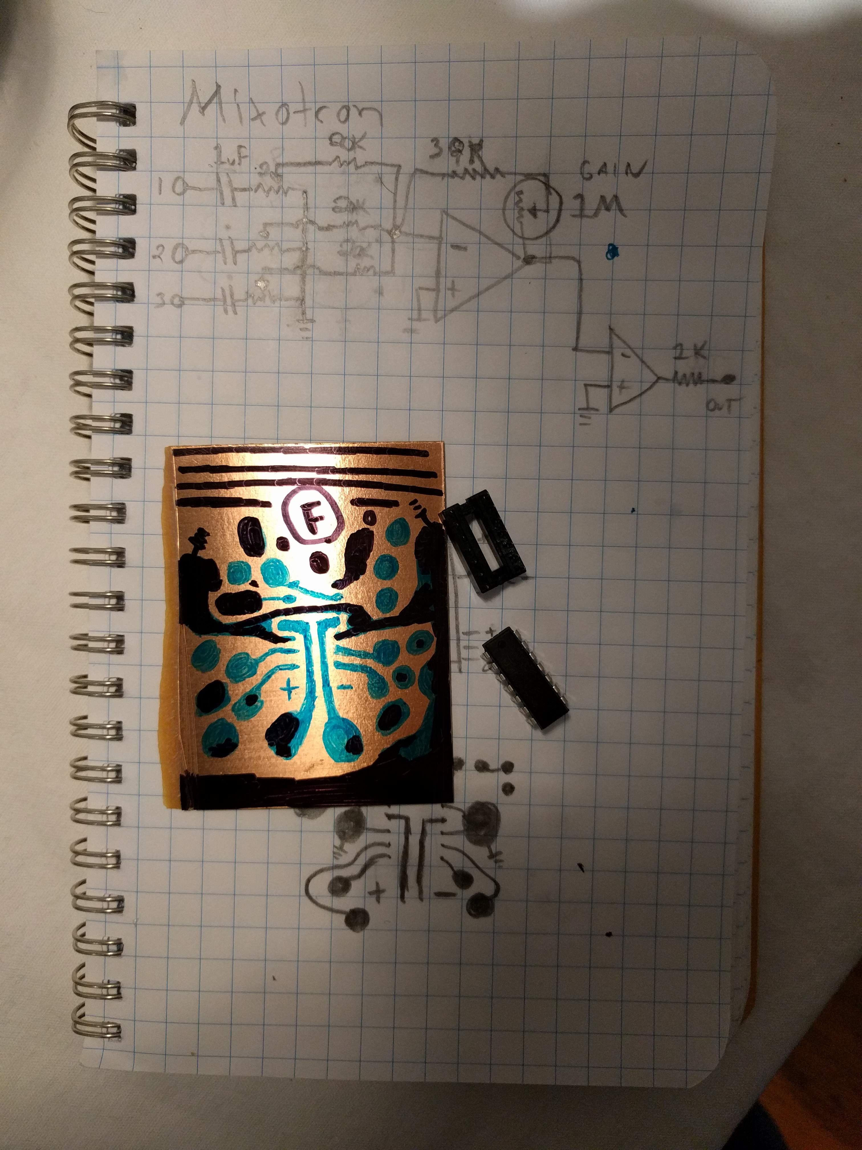 Photograph of a hand-drawn circuit diagram for a 4-channel mixer and a sketch of that circuit on a small piece of copper-clad board in sharpie.